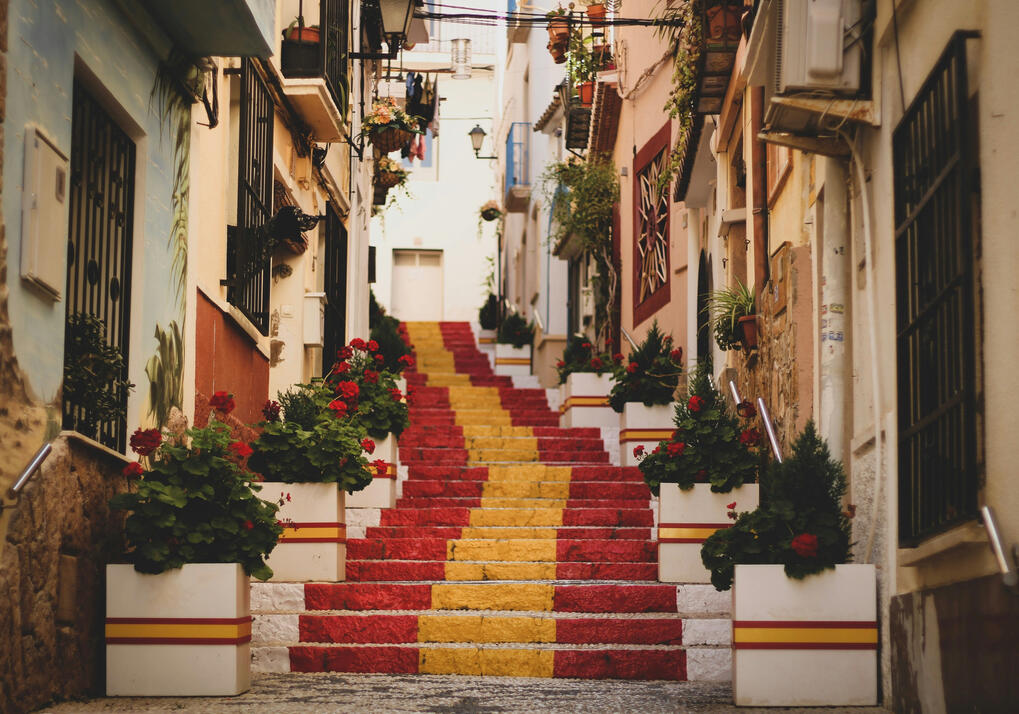 Colourful red and yellow painted staircase in a Spanish town